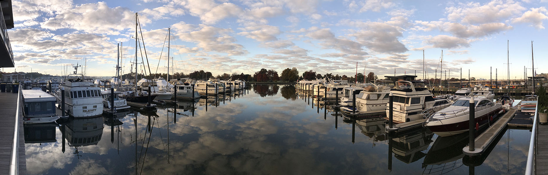 180 Degree views of Marina with Blue Sky and Puffy Clouds Reflected in the Water.